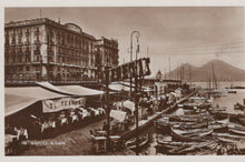 Load image into Gallery viewer, Vintage photograph of a waterfront scene with boats and buildings, featuring a large sign.

