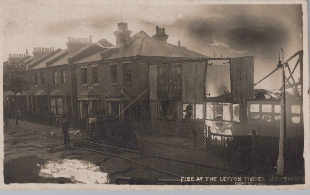 Burnt-out building with surrounding houses in a residential area, likely after a fire.