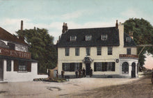 Load image into Gallery viewer, Vintage postcard of a pub with people outside, surrounded by trees and other buildings.
