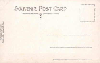 Vintage-style souvenir postcard with decorative text and a blank area for writing.