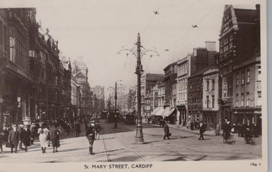 Vintage black and white photograph of St. Mary Street, Cardiff with pedestrians and streetcars.