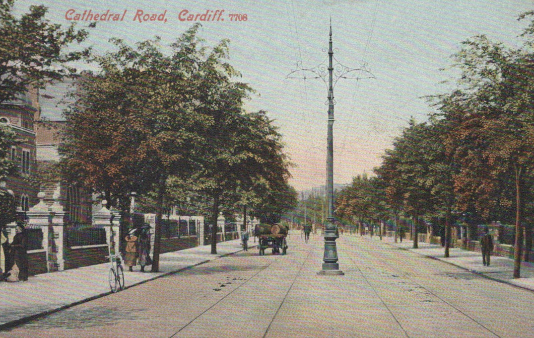 Vintage postcard of Cathedral Road, Cardiff, showing a street scene with trees, people, and a tram line.