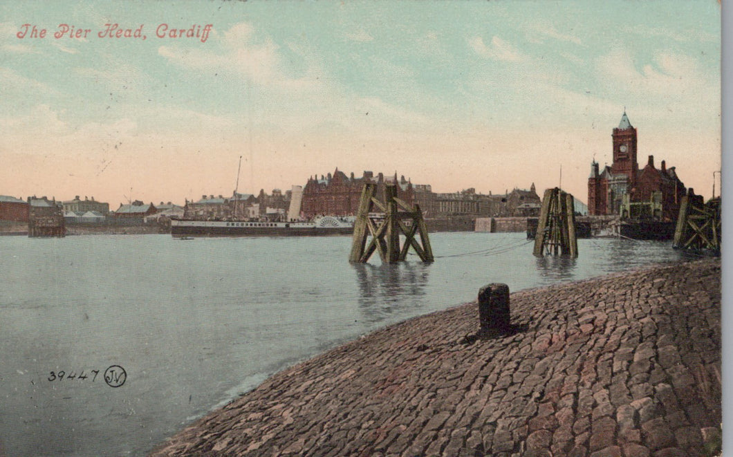 Vintage postcard of a waterfront scene with a dock and buildings in Cardiff, Wales.
