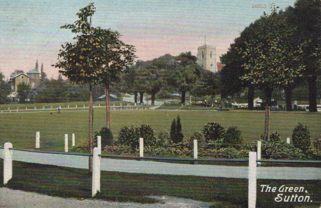 Vintage postcard of a park with trees and buildings in the background, labeled 'The Green, Sutton'.