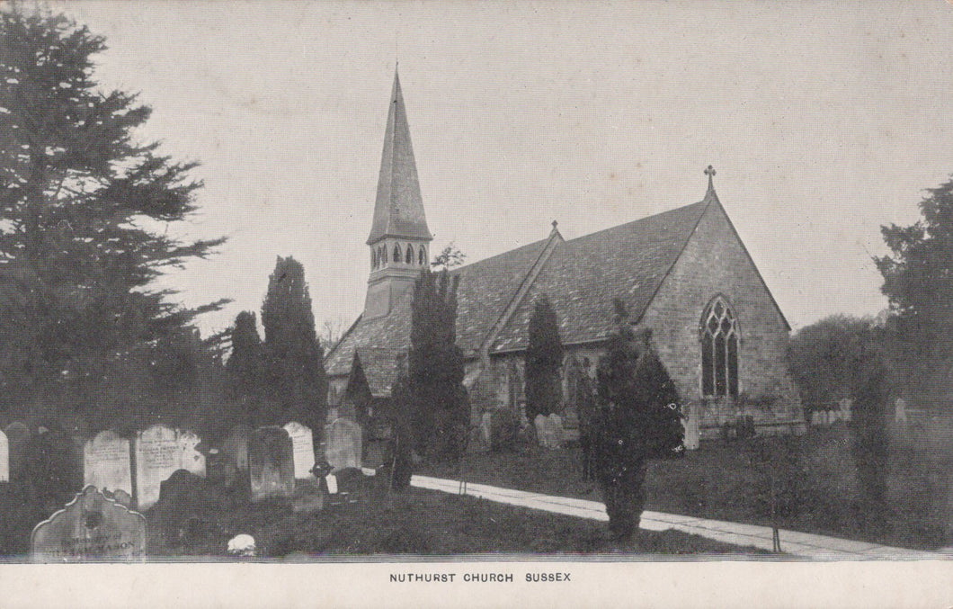 Vintage photograph of a church with a steeple and gravestones in the foreground.