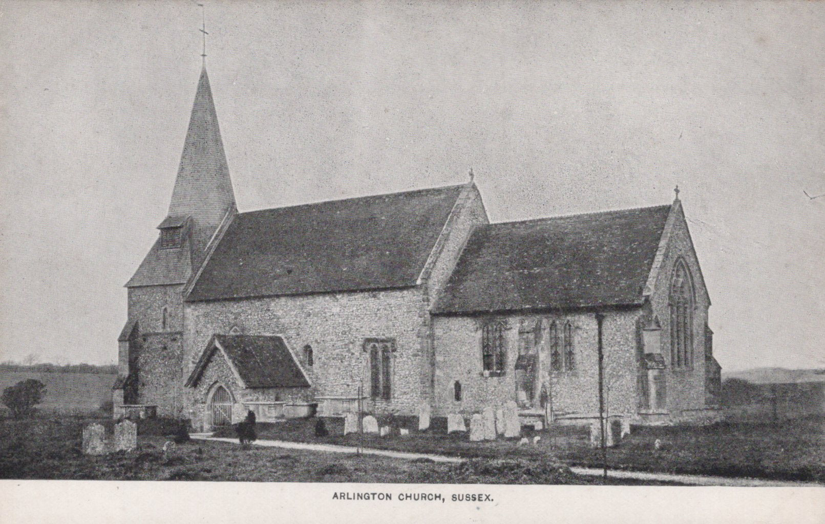 Vintage black and white photograph of a church with a steeple in a rural setting.