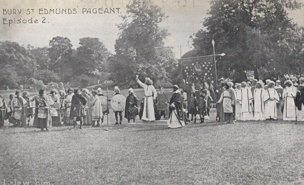 Vintage black and white photo of a pageant event with people in formal attire outdoors.