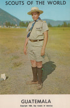 Load image into Gallery viewer, Scout in uniform standing outdoors with mountains in the background, labeled &#39;Scouts of the World Guatemala&#39;.
