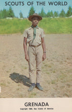Load image into Gallery viewer, Scout in uniform standing in a field with &#39;Scouts of the World Grenada&#39; text at the top.
