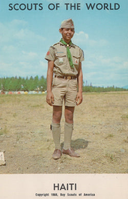 Scout in uniform standing in an open field with 'Scouts of the World' and 'Haiti' text.