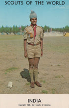 Load image into Gallery viewer, Scout in uniform with a badge, standing outdoors with &#39;Scouts of the World&#39; text at the top.
