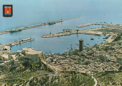 Aerial view of a coastal city with a large body of water and a long pier.