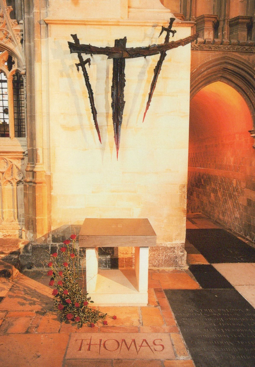 Memorial with swords on a wall in a cathedral setting