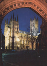 Load image into Gallery viewer, Cathedral at night viewed through an archway
