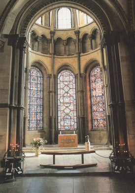Altar with stained glass windows in a cathedral setting