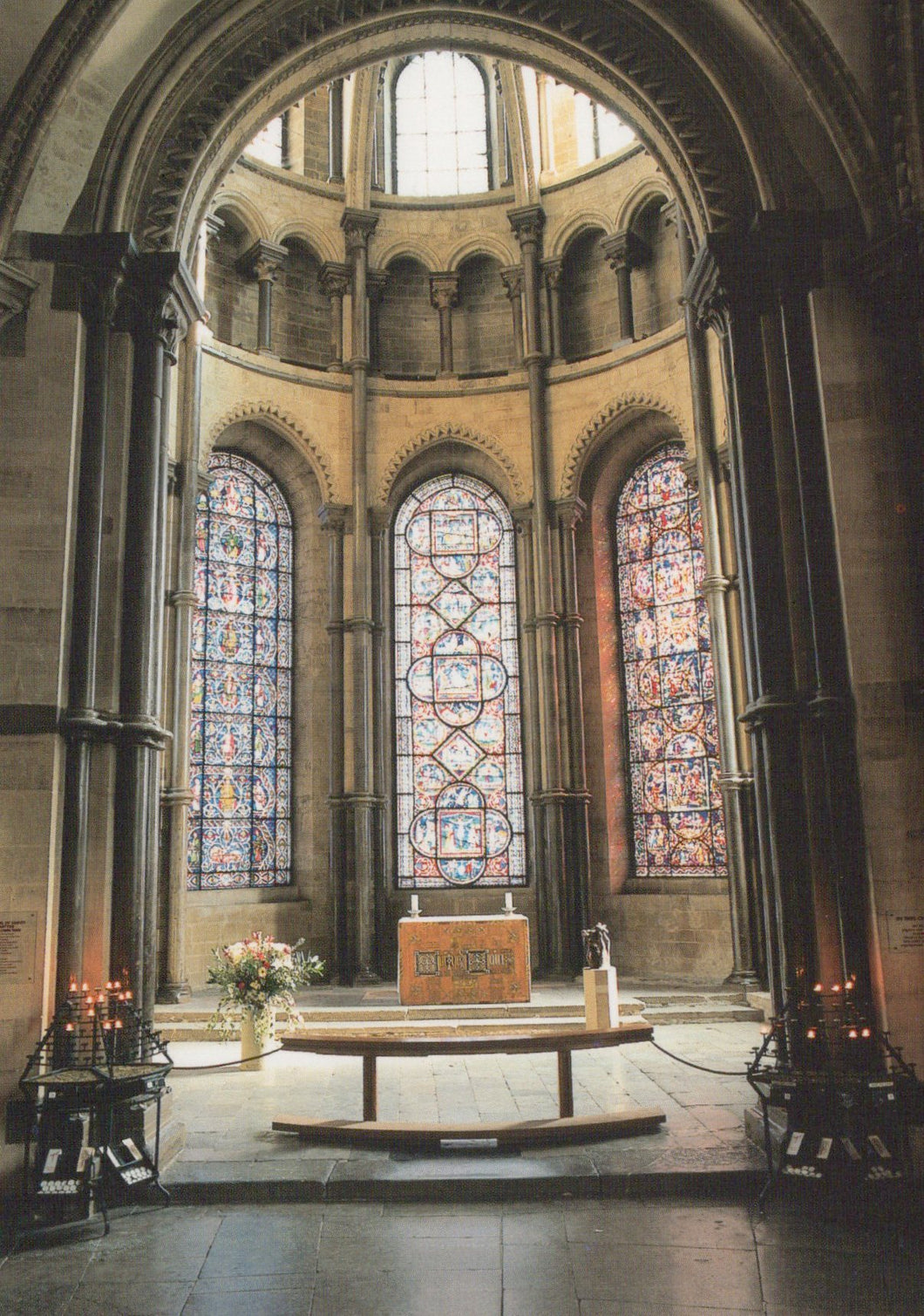 Altar with stained glass windows in a cathedral setting