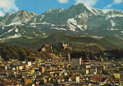 Cityscape with a castle and mountains in the background