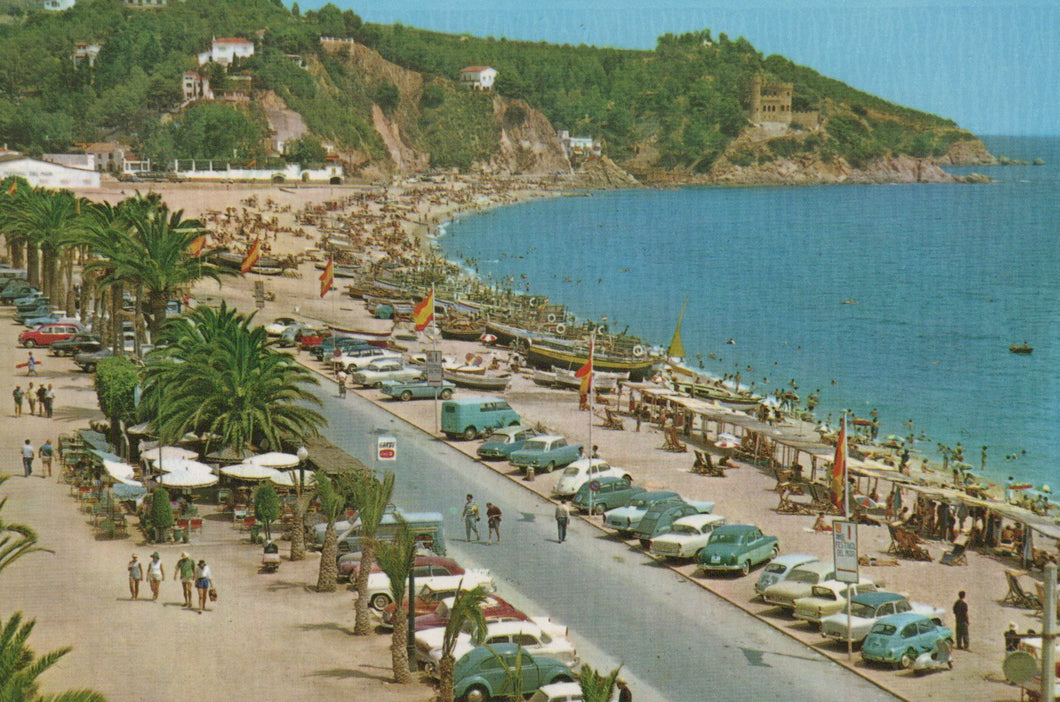 Vintage postcard of a coastal scene with cars, palm trees, and a beach.