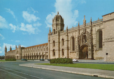 Large stone building with architectural details under a blue sky