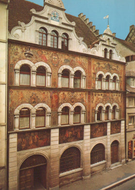 Decorative building facade with artistic murals on a street corner.
