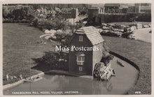 Load image into Gallery viewer, Model village scene with a mill and people around a pond, labeled &#39;Mo&#39;s Postcards&#39;.
