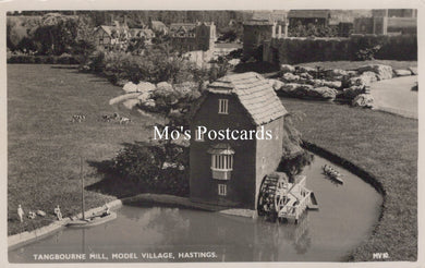 Model village scene with a mill and people around a pond, labeled 'Mo's Postcards'.