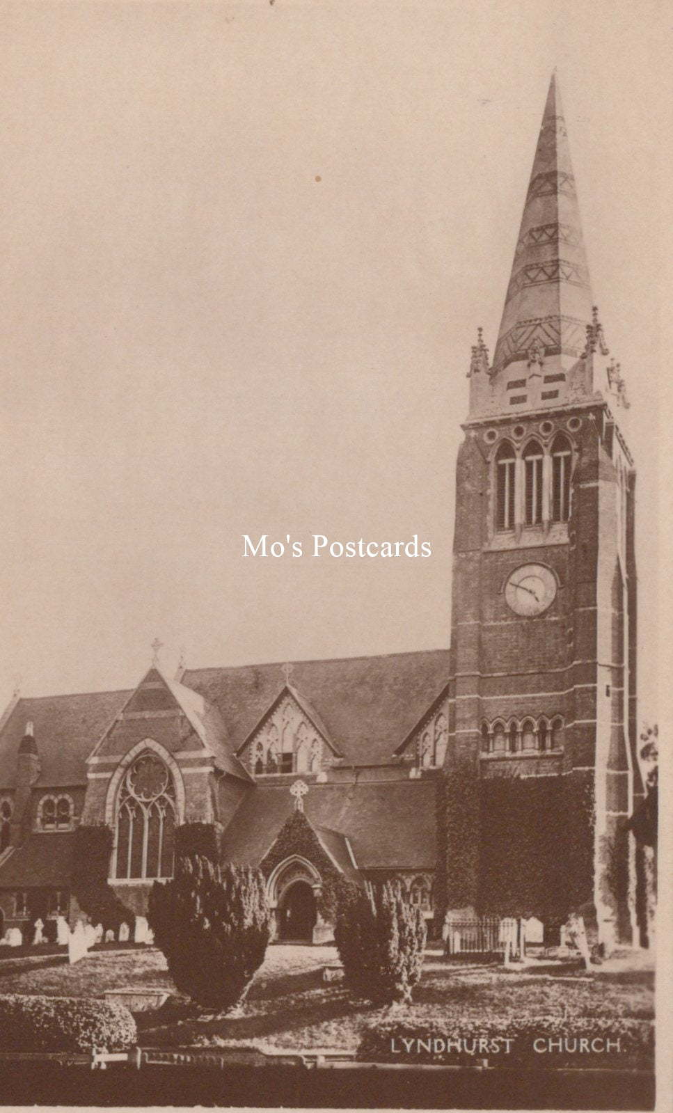 Vintage photograph of a church with a tall steeple, labeled 'Mo's Postcards'.