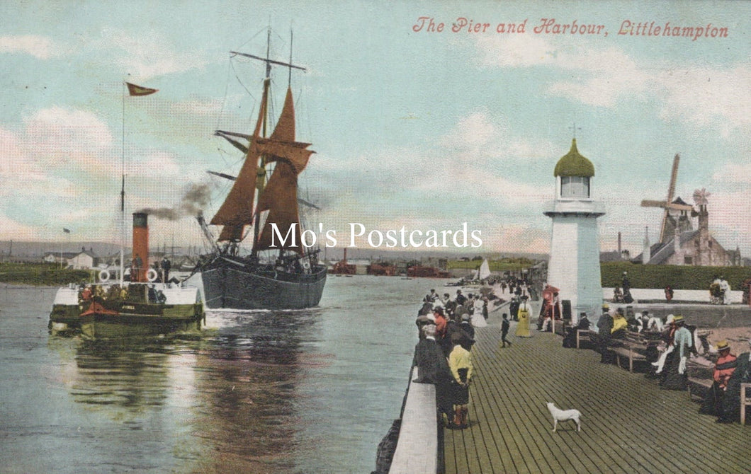 Vintage postcard of a pier and harbour scene with steamships and people.