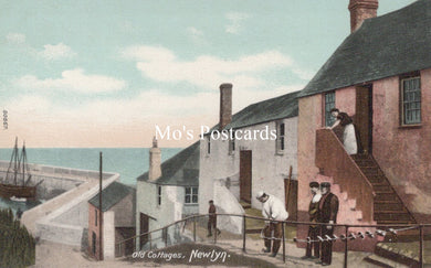Vintage postcard of Old Cottages in Newlyn with people on a staircase.