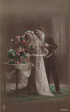 Load image into Gallery viewer, Vintage-style postcard of a couple with flowers and a tablecloth.
