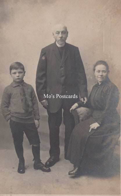 Vintage black and white photo of a family posing together with 'Mo's Postcards' text.