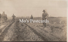 Load image into Gallery viewer, Vintage black and white photo of people working in a field  
