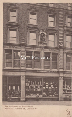 Vintage black and white postcard of a building facade with a store front, labeled 'Mo's Postcards'.