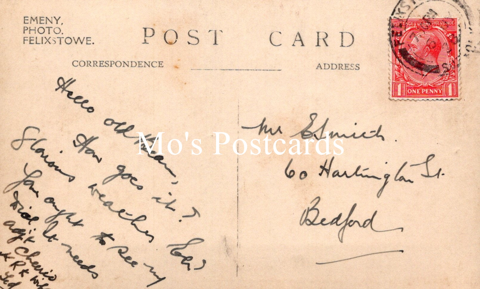 Vintage postcard with handwritten text and a red postage stamp 