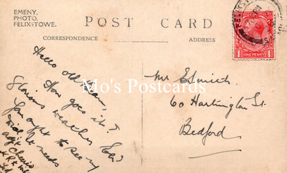 Vintage postcard with handwritten text and a red postage stamp 