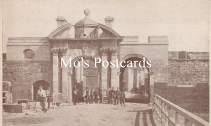 Vintage black and white photo of a stone building with people gathered outside 