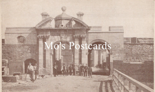 Vintage black and white photo of a stone building with people gathered outside 