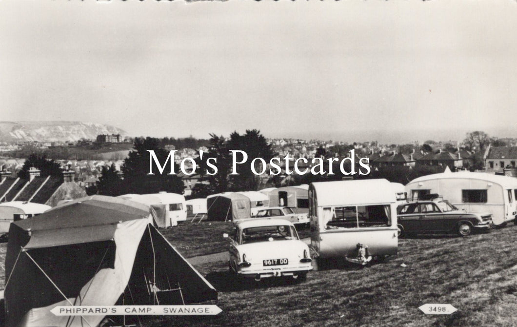 Vintage black and white photo of caravans and tents at a campsite  