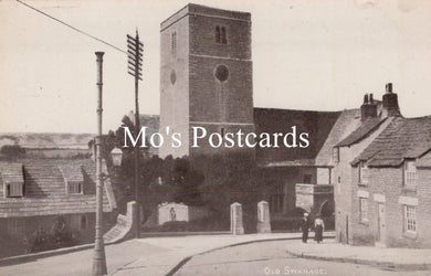 Vintage black and white photo of a street scene with a church tower and buildings 