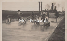 Load image into Gallery viewer, Vintage black and white photo postcard of people working on a road  
