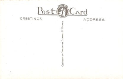 Back of a postcard with 'Greetings' and 'Address' text, featuring a logo.