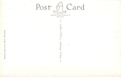 Back of a postcard with text and a logo on a white background