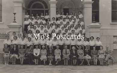 Black and white group photo of people in front of a building 
