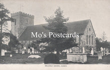Load image into Gallery viewer, Vintage black and white postcard of a church with gravestones and trees
