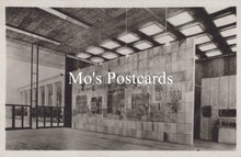 Load image into Gallery viewer, Vintage interior of a building with large wall murals  
