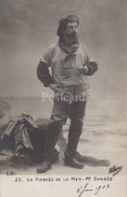 Load image into Gallery viewer, Vintage postcard of a man in a fishing outfit with text and signature
