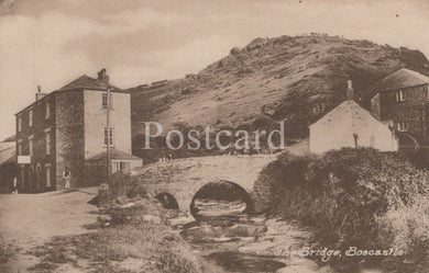 Vintage postcard of a bridge in Boscastle, featuring a stone building and natural landscape.