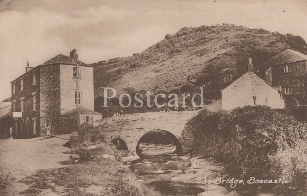 Vintage postcard of a bridge in Boscastle, featuring a stone building and natural landscape.