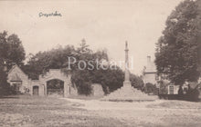 Load image into Gallery viewer, Vintage black and white postcard of a gatehouse and cross in a park-like setting with trees.
