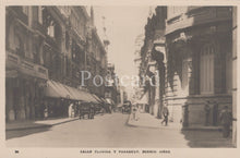 Load image into Gallery viewer, Vintage black and white postcard of a street scene in Buenos Aires with people and vehicles.
